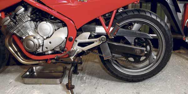 Make sure the motorbike is on its centre stand Make sure the motorbike is on its centre stand