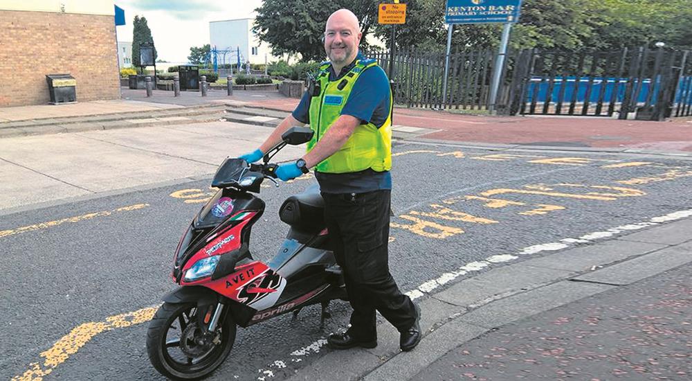 Policeman with recovered scooter Policeman with recovered scooter