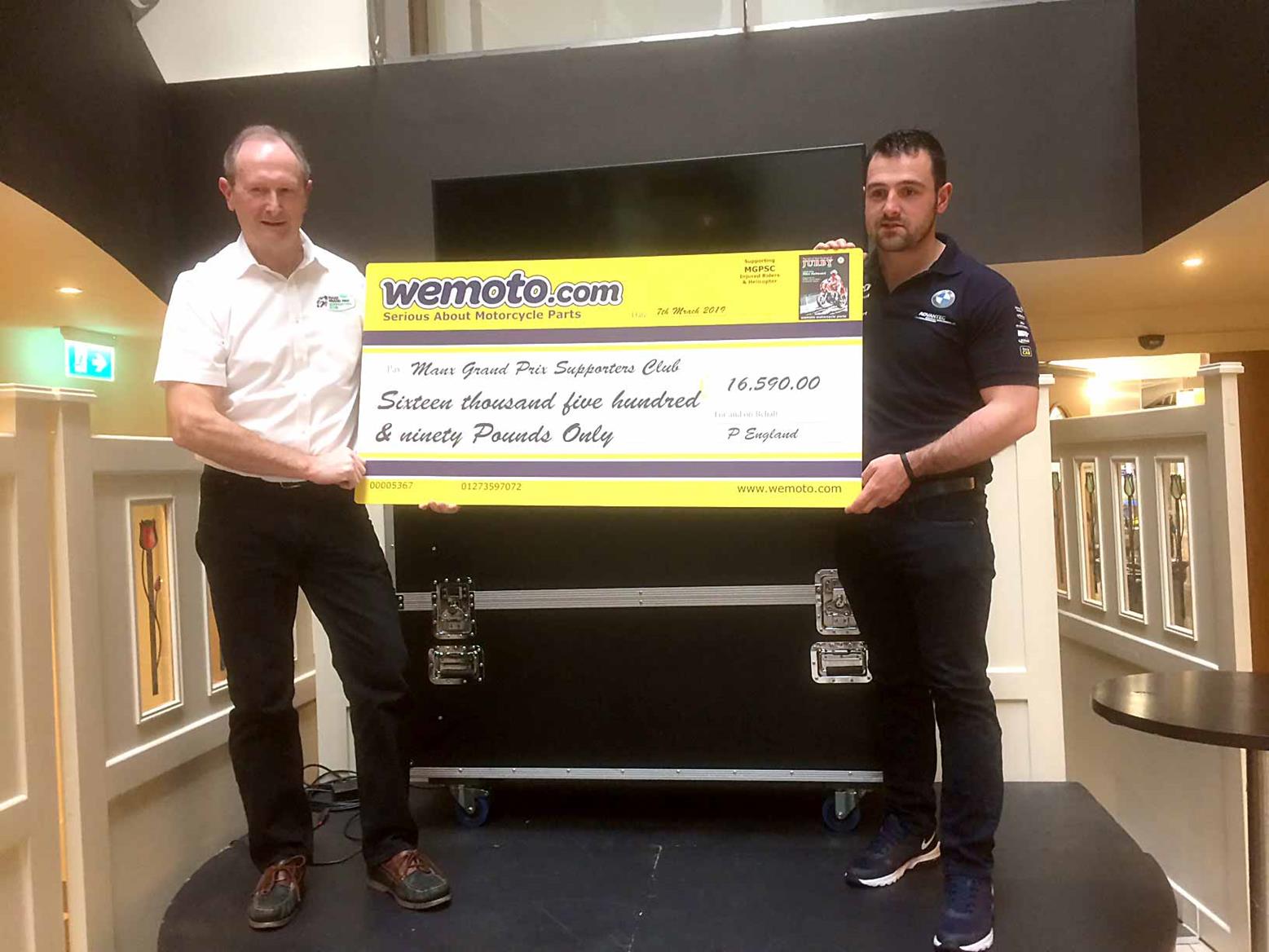 Michael Dunlop helps present a cheque Michael Dunlop helps present a cheque