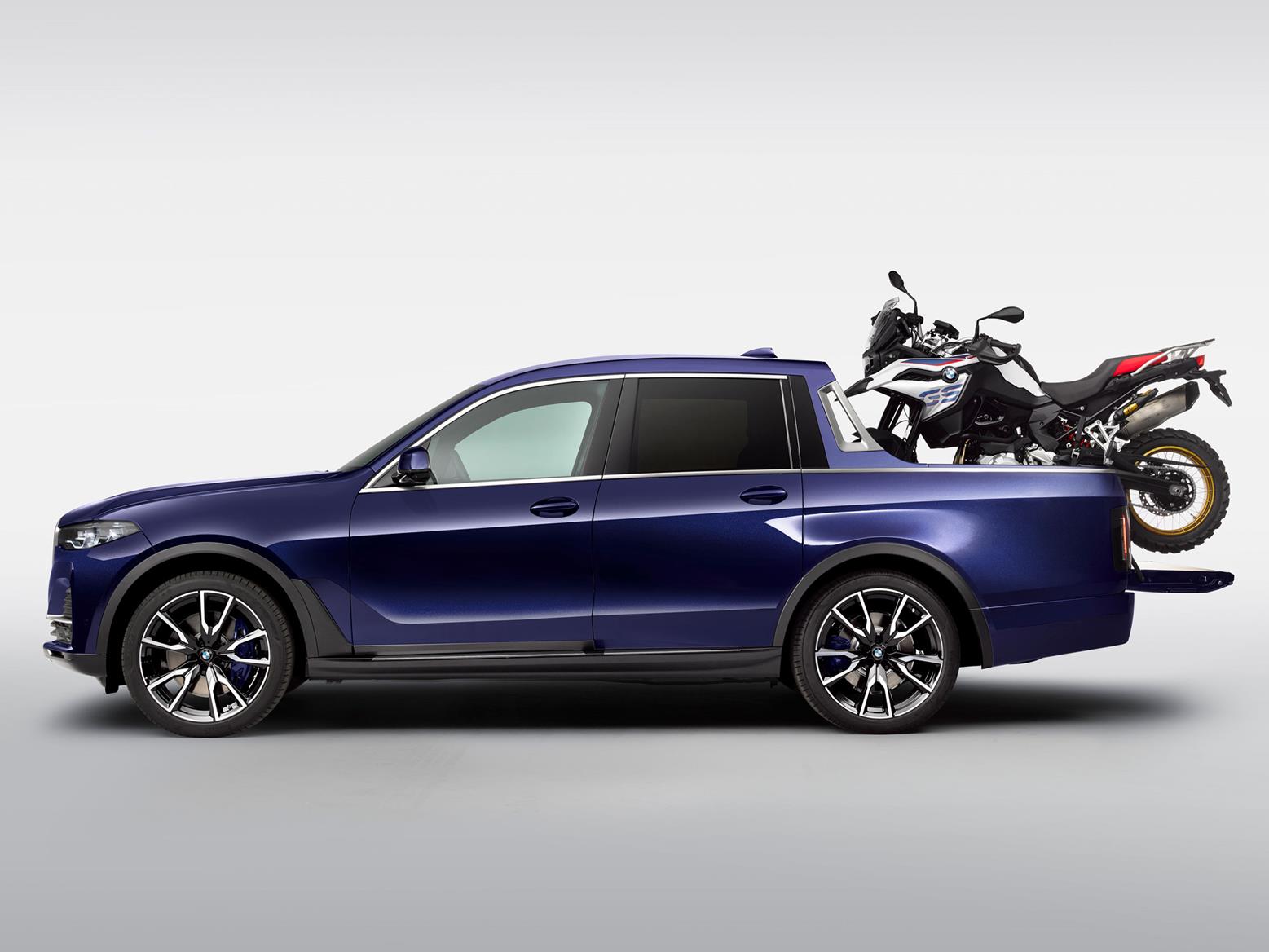 Side profile of BMW X7 pickup with F 850 GS Sport on the load area Side profile of BMW X7 pickup with F 850 GS Sport on the load area