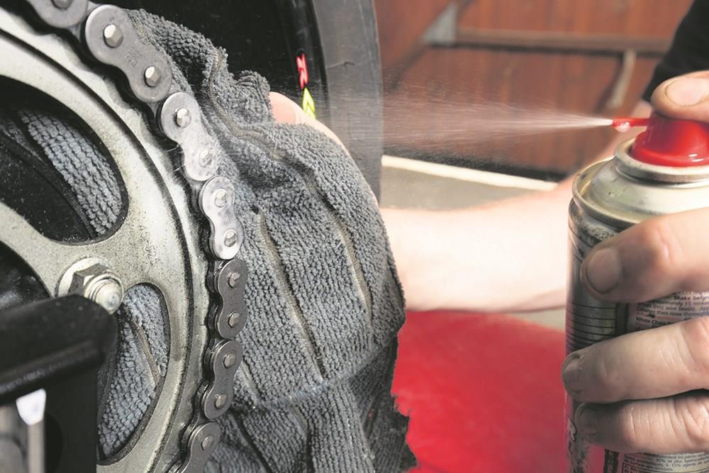Applying chain lube to a motorcycle chain Applying chain lube to a motorcycle chain