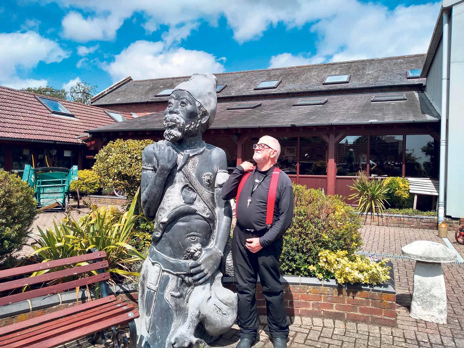 Phil poses with a statue Phil poses with a statue