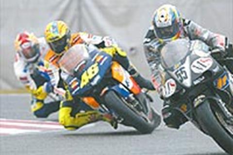 Rossi takes pole at damp Assen