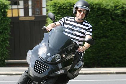 TV host Jonathan Ross riding a Piaggio MP3