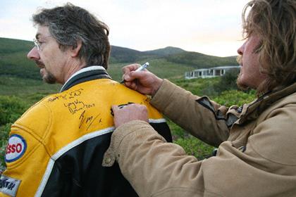 Keith Elgin having his jacket signed by Charley Boorman