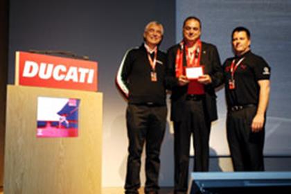 Ducati's Chief Executive Officer, Gabriele Del Torchio and Distributor Sales Director, Brad Hagi present award to Robert Zarzour, Director of Motorcycles and Lifestyles at the Alfardan Motorcycles Centre