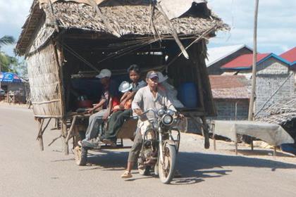 This is a complete house with it's contents and occupants still in it being moved on a trailer on the back of a 125cc bike