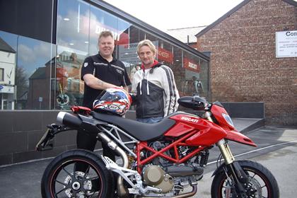 Carl Fogarty picks up his Ducati Hypermotard S