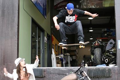 Pro skateboarder Ryan Sheckler jumping his Roland Sands bike