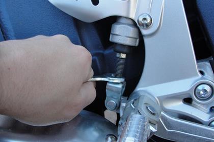 Loosening the lock nut to adjust the brake pedal up slightly