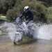 Ducati DesertX splashing through water