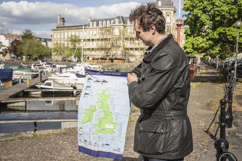 Harry Bott holds up a map of the UK