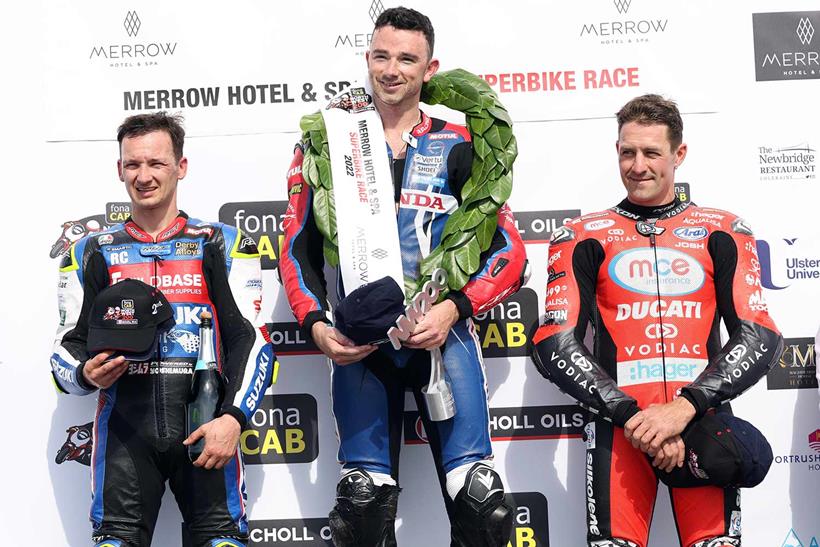 Glenn Irwin is joined by Richard Cooper (left) and Josh Brookes (right) on the podium