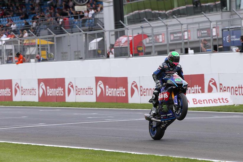 Jason O'Halloran celebrates victory with a wheelie at Donington