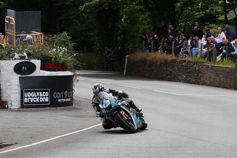 Michael Dunlop rounds Ballacraine Corner on his MD Racing Carl Cox Yamaha on his way to his 20th TT victory