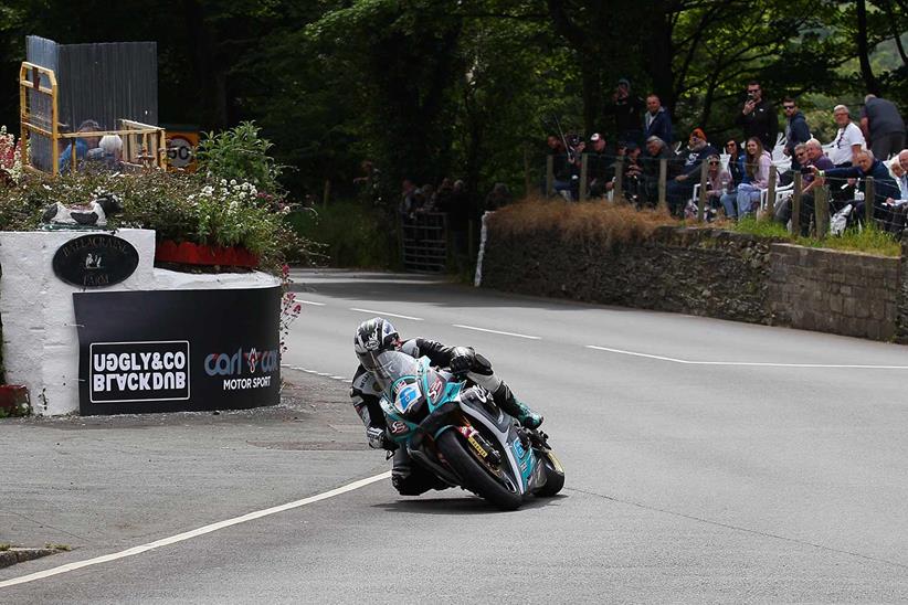 Michael Dunlop rounds Ballacraine Corner on his MD Racing Carl Cox Yamaha on his way to his 20th TT victory