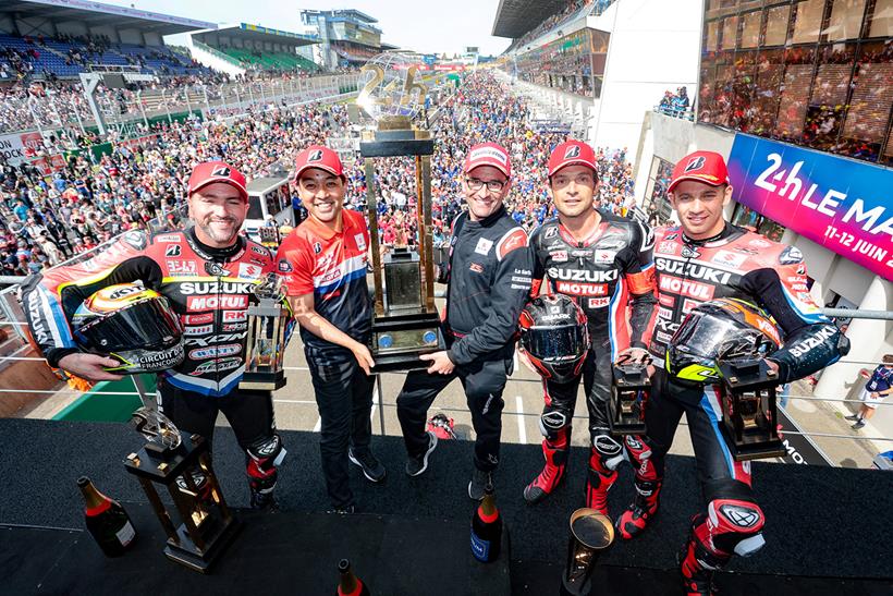 Suzuki world endurance champions lifting the trophy in front of crowd