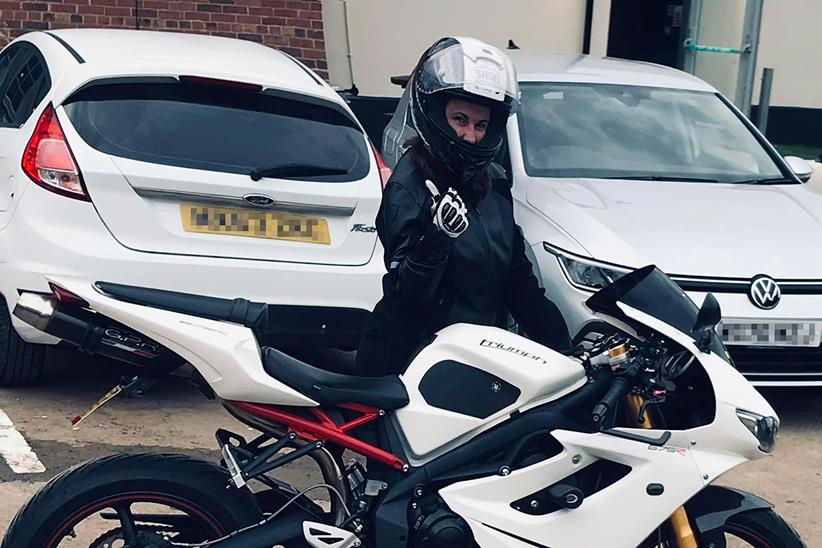 Sarah Mitchell poses with her Triumph Daytona 675R in riding gear