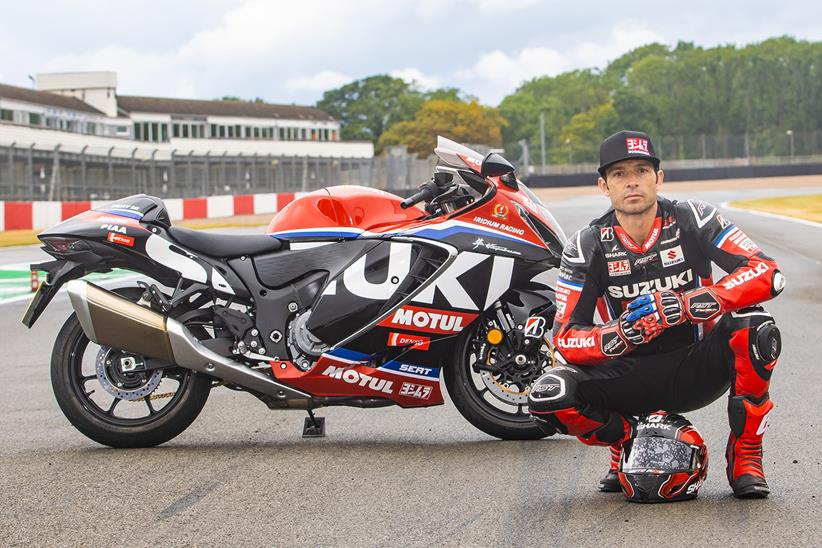 Sylvain Guintoli crouched next to Suzuki Hayabusa