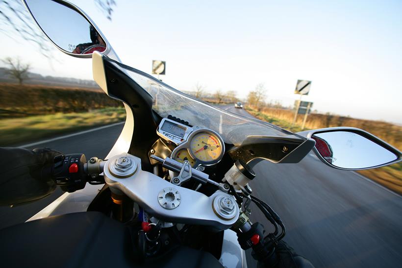 Entering a national speed limit stretch of road on a motorbike