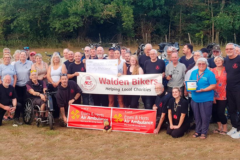 Walden Bikers pose with cheque