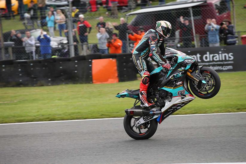 Peter Hickman pulls a wheelie to celebrate victory at Brands Hatch