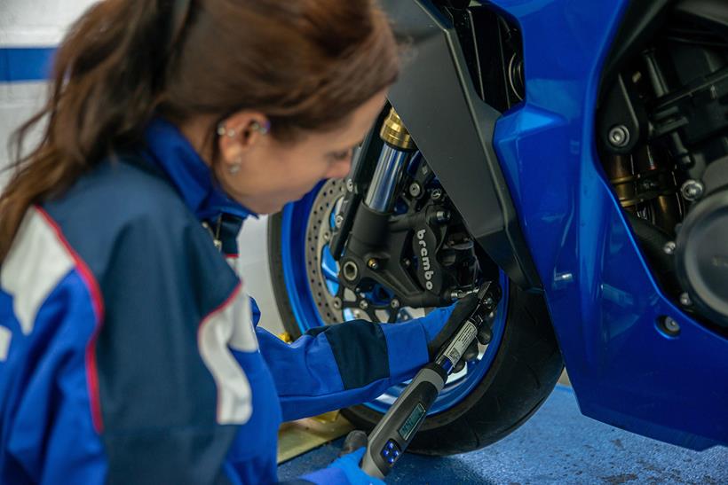 Suzuki mechanic repairing a GSX-S1000GT