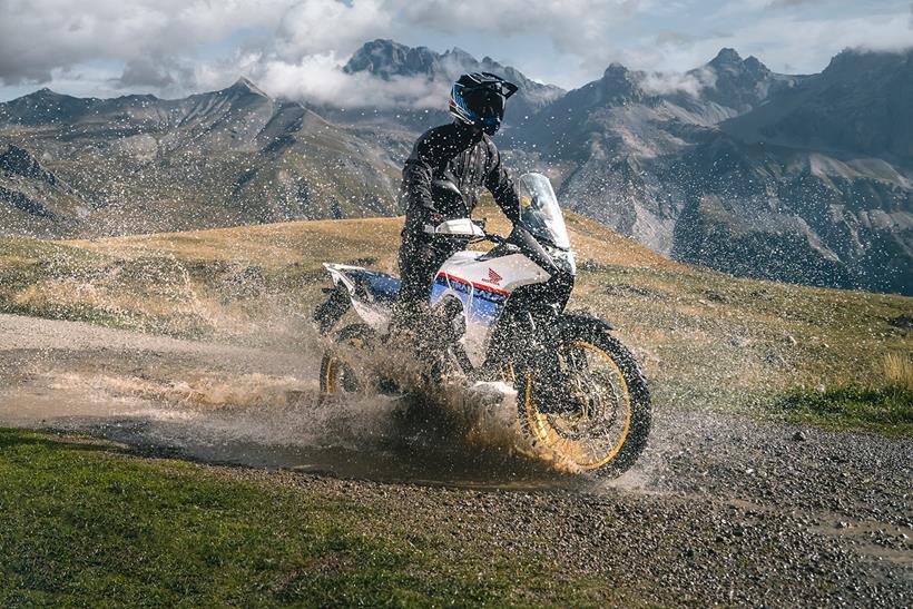 2023 Honda Transalp splashes through a puddle