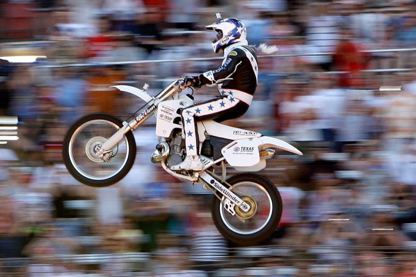 Robbie Knievel jumping a Honda CR500 in front of a crowd