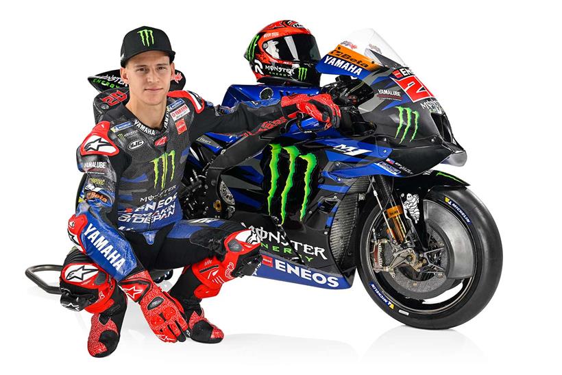 Fabio Quartararo knelt next to the 2023 Monster Energy Yamaha M1