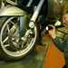 Checking a motorcycle's front wheel with a torch