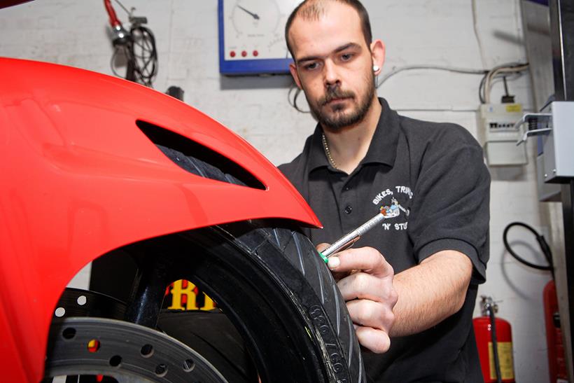 MoT tester checking tyre tread depth