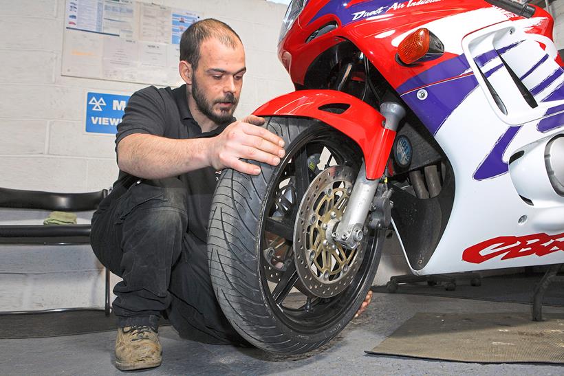 MoT tester checking bearings for free play