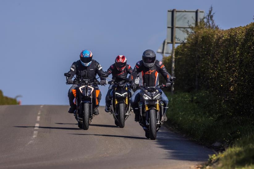 Three motorcyclists riding together