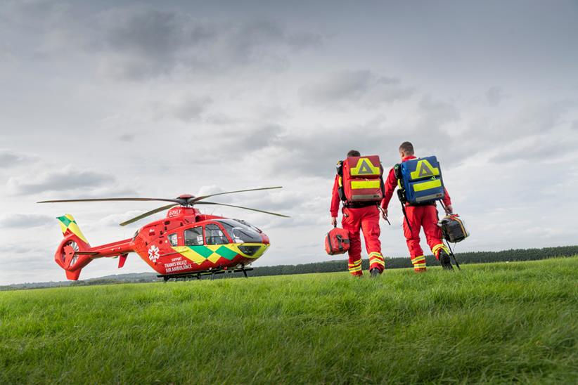 Thames Valley Air Ambulance team walk back to the helicopter