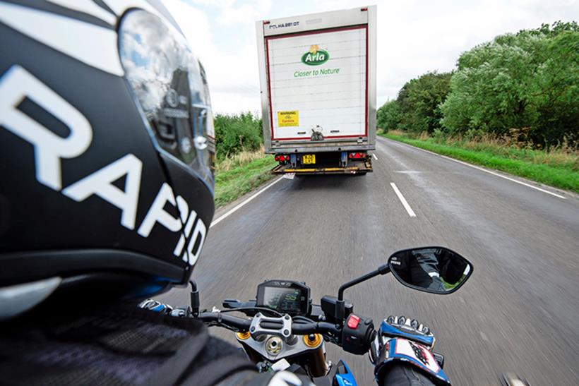 A motorcyclist preparing to overtake a lorry