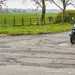 Motorbike on UK road with potholes