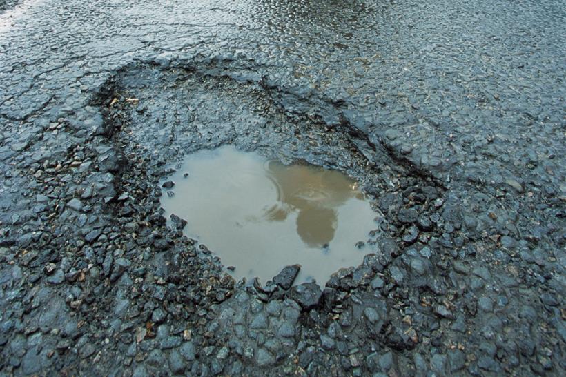 A deep pothole filled with water