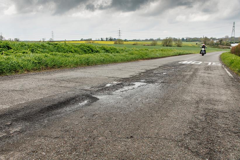 Riding a motorbike towards a pothole in the UK