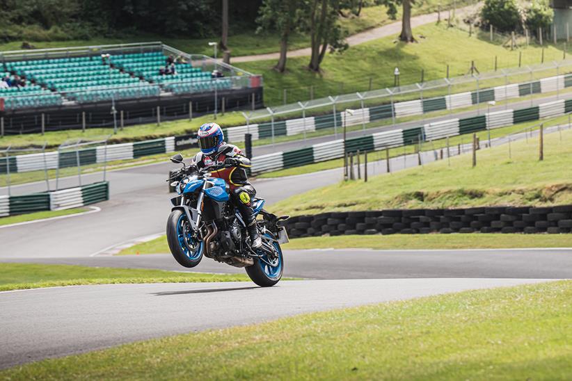 Steve Parrish wheelies a Suzuki GSX-8S over the Cadwell Park Mountain