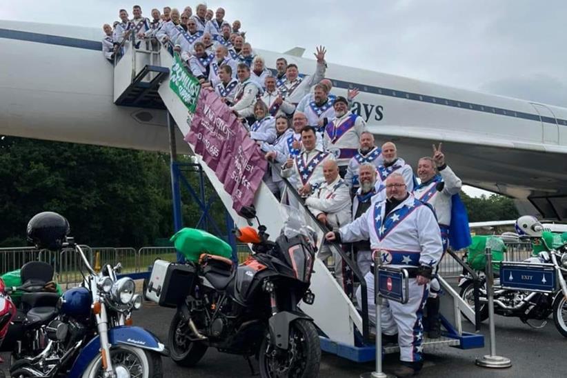 Knievel charity riders on plane stairs