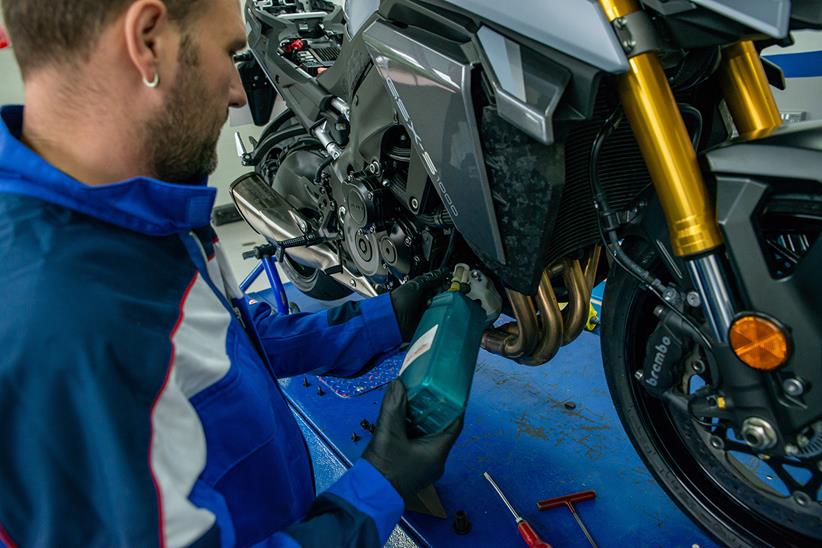 A Suzuki technician completes a service