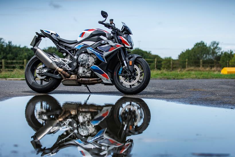 BMW M1000R long-term test bike reflected in a puddle