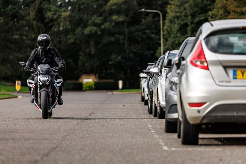 BMW M1000R long-term test bike commuting through town