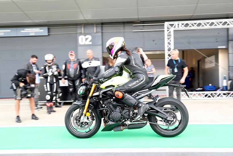 Triumph Street Triple 765 Moto2 riding down pit lane