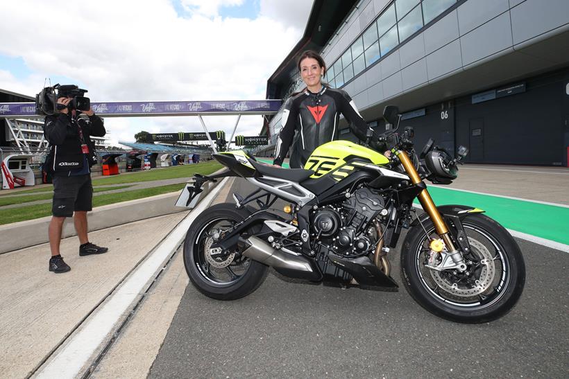 Emma Franklin stands with the Triumph Street Triple 765 Moto2