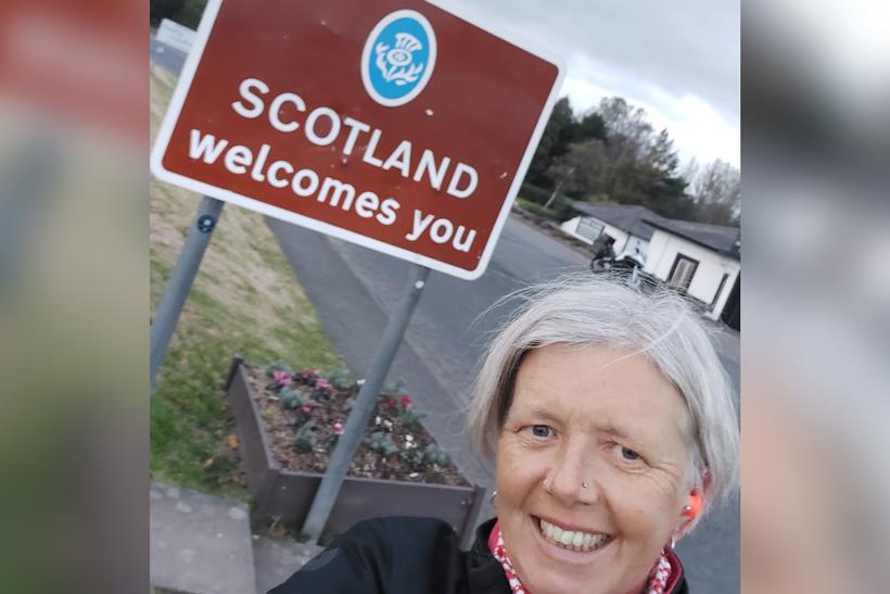 Ali Silcox with the welcome to Scotland sign