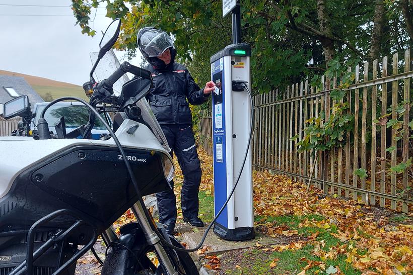 Ali Silcox uses a public charger to fill up the Zero DSR/X