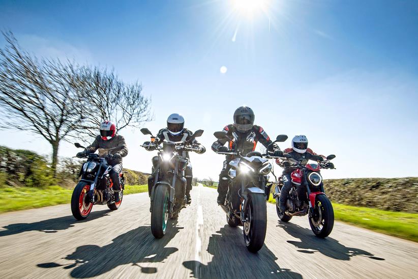 Four sports naked motorcycles being ridden on UK roads