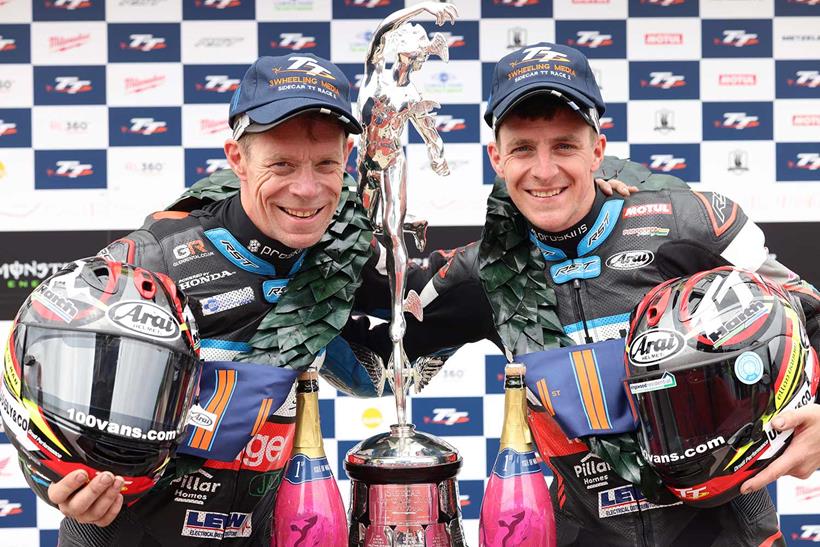 Ben and Tom Birchall celebrate winning the second sidecar race at the 2023 TT (Credit: Stephen Davison / Pacemaker Press)